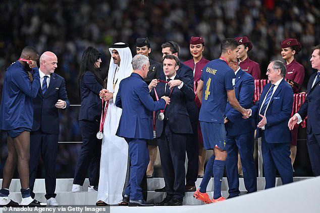 During the presentation of the trophy, French President Emmanuel Macron gives the medal to Didier Deschamps, who is the head coach of France.