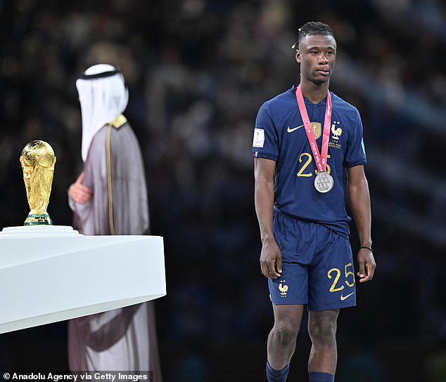 France's Eduardo Camavinga, age 25, is seen with the medal and the trophy.