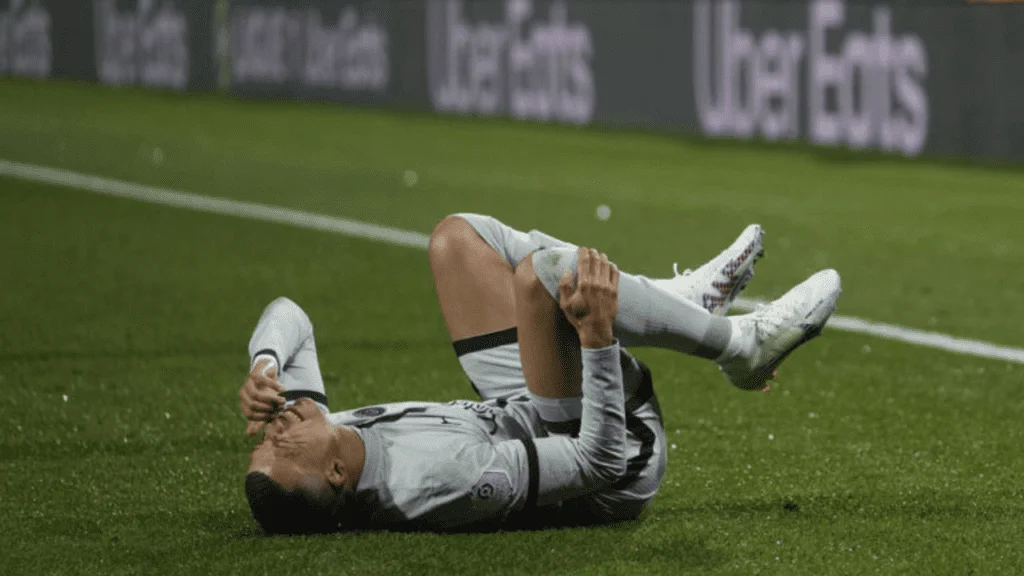 Injured Kylian Mbappe grimaces in pain during the French League One soccer match between Montpellier and Paris Saint-Germain at the State La Mosson stadium in Montpellier, France, Wednesday, Feb. 1, 2023.