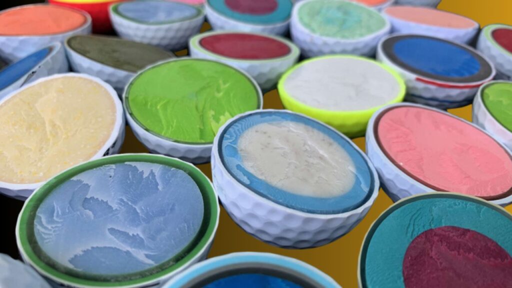 Golf balls being cut from the center to examine their internal structure.