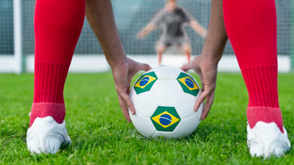 Players taking penalty shots during a tense penalty shootout in a soccer match.