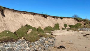 A piece of an old golf course falls into the water. @BBC