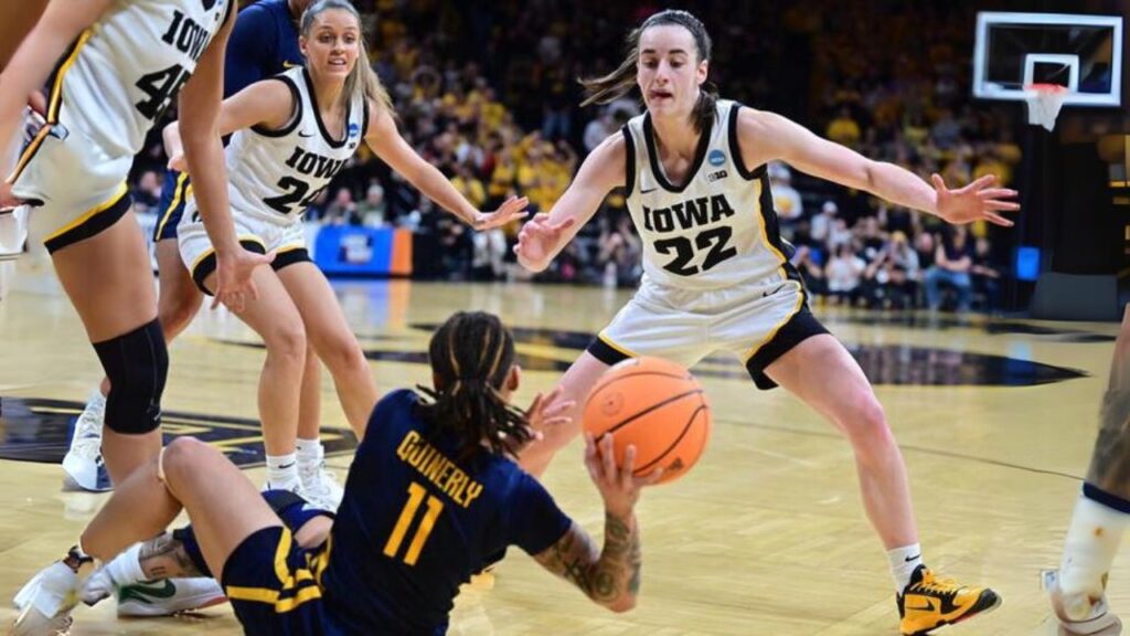 During the West Virginia Mountaineers game against the Iowa Hawkeyes, Caitlin Clark (22) protects.
