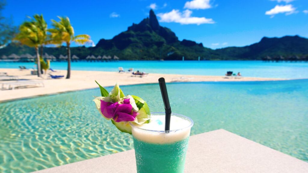 A stunning aerial view of Bora Bora, showcasing its turquoise lagoon and lush green islands in the Pacific Ocean.