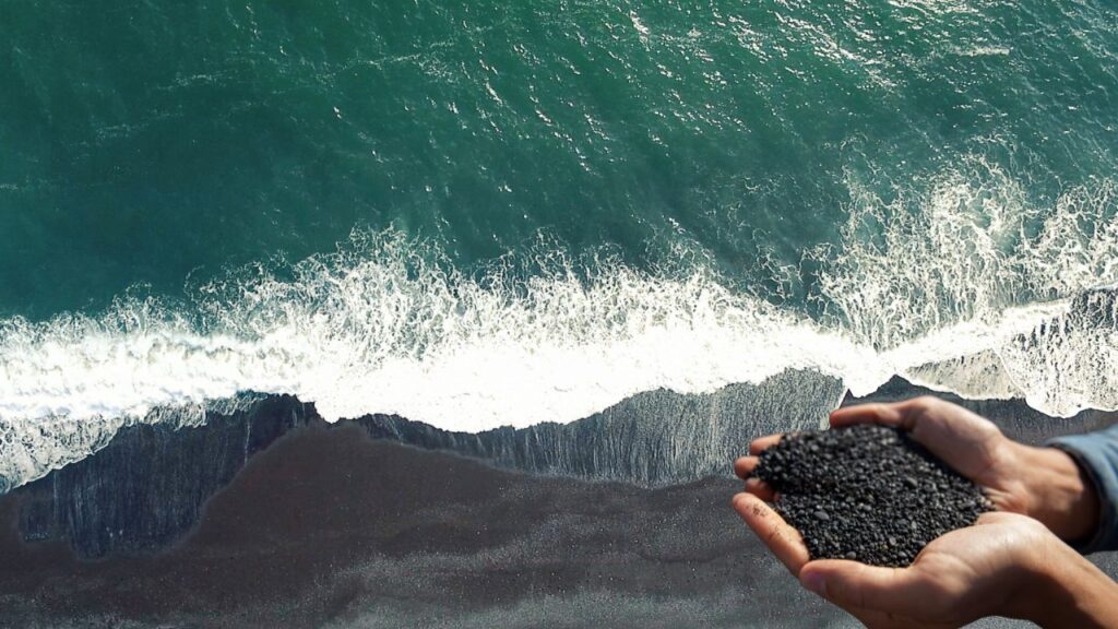 A dramatic view of Reynisfjara Black Sand Beach in Iceland, showcasing its unique black sands, powerful waves, and striking sea stacks.