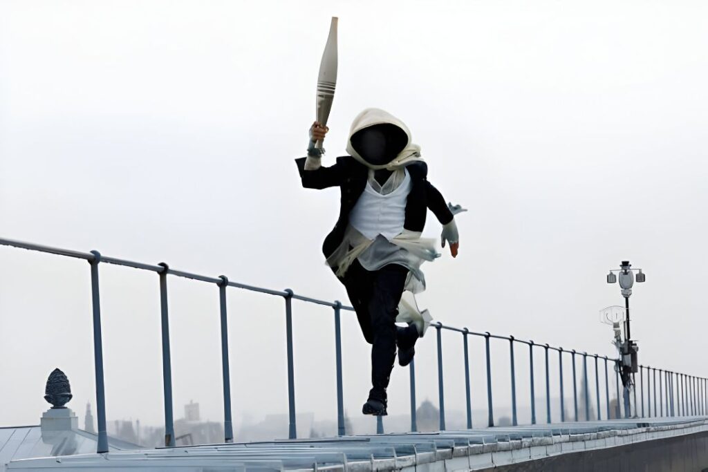 A man in a mask carrying a torch shows off his speed ( Image: Getty Images)