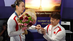 Yu Chen Liu of Team People's Republic of China proposes to Gold Medalist Ya Qiong Huang after the Badminton Mixed Doubles medal ceremony following the Mixed Doubles Badminton matches on August 2, 2024, at the Porte de La Chapelle Arena in Paris, France. This happened on the seventh day of the Olympic Games Paris 2024. (Getty Images photo by Julian Finney))