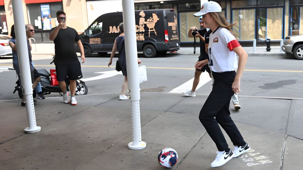 On August 15, 2024, Olympic Gold Medalist and U.S. Women's National Team Star Defender Tierna Davidson kicks a soccer ball at Raising Cane's Astor Place in New York City in her Olympic Homecoming. For Raising Cane's, Noam Galai/Getty Images.