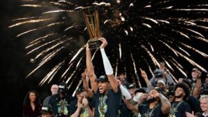 Giannis Antetokounmpo celebrating after being named MVP following the Bucks' NBA Cup victory.