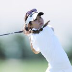 Jasmine Koo posing confidently on the golf course, showcasing her talent as a rising star in American golf.