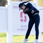 Jasmine Koo posing with her golf club at USC's golf course.