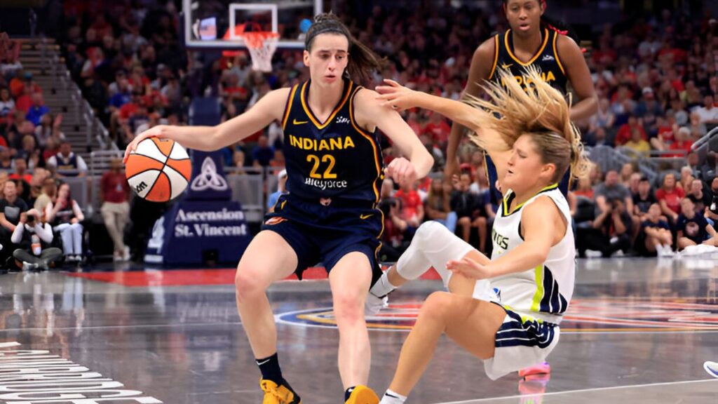 Caitlin Clark of the Indiana Fever drives to the basket against Jacy Sheldon of the Dallas Wings at Gainbridge Fieldhouse.